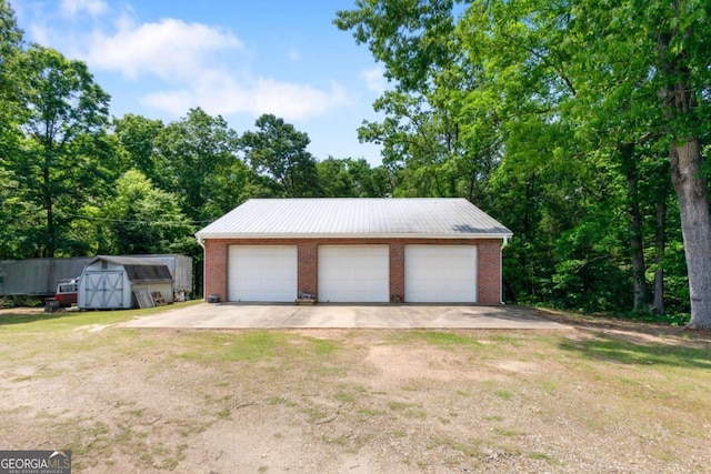 detached garage featuring a storage shed