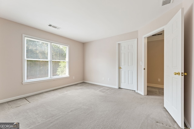 unfurnished bedroom featuring carpet flooring and baseboards