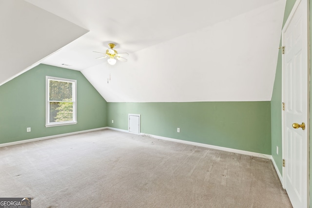 additional living space with carpet floors, baseboards, ceiling fan, and lofted ceiling