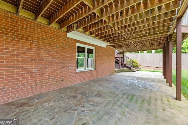 view of patio / terrace with fence and stairs