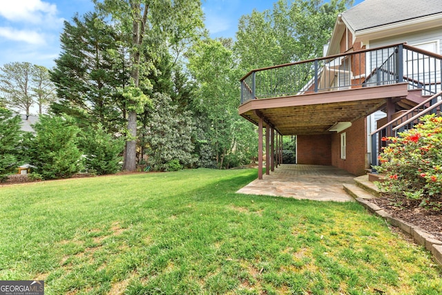 view of green lawn featuring a patio area, a deck, and stairway