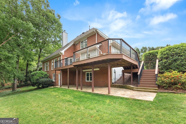 back of house featuring brick siding, a patio, a yard, and a chimney
