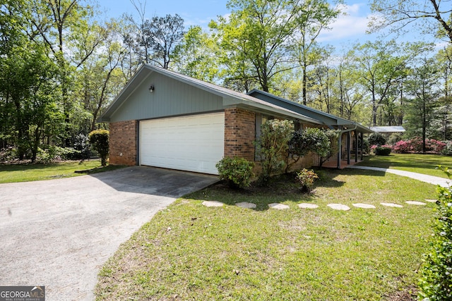 182 Quail Hollow Ln, Fort Valley, GA 31030 - view of side of home featuring a garage, a yard, brick siding, and driveway