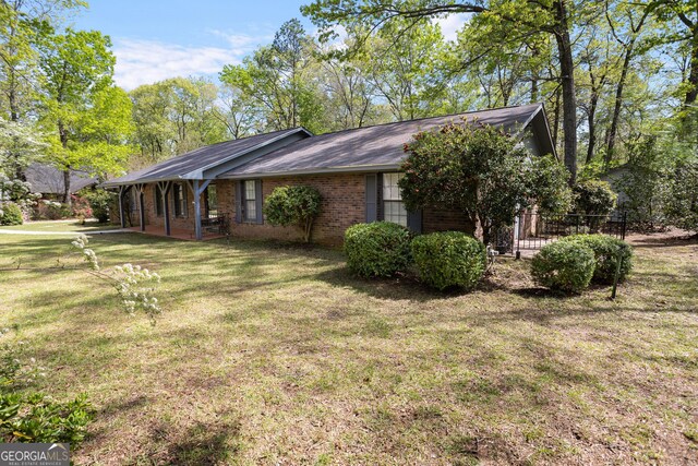 182 Quail Hollow Ln, Fort Valley, GA 31030 - view of side of home featuring a yard and brick siding
