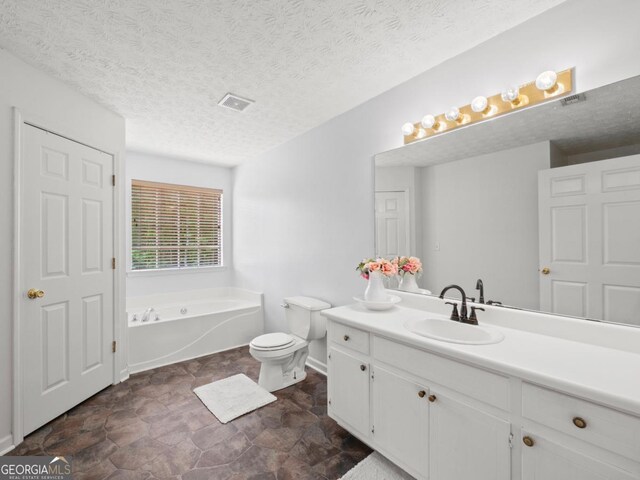 5293 Hopewell Ln, Gainesville, GA 30507 - full bath featuring a bath, toilet, stone finish floors, vanity, and a textured ceiling