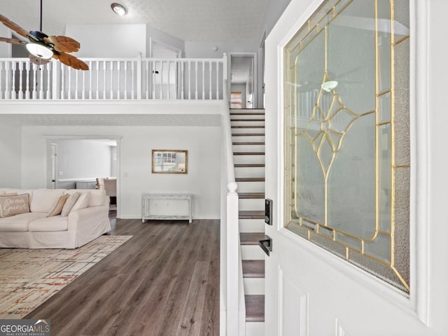 5293 Hopewell Ln, Gainesville, GA 30507 - living room with wood finished floors, ceiling fan, and stairway
