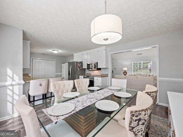 5293 Hopewell Ln, Gainesville, GA 30507 - dining area with wood finished floors, a textured ceiling, and baseboards
