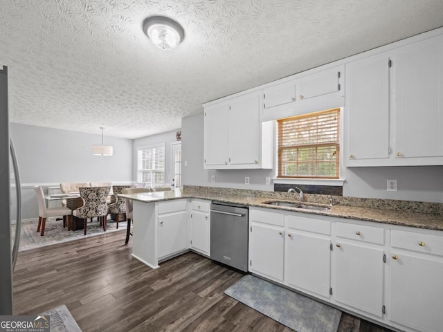 5293 Hopewell Ln, Gainesville, GA 30507 - kitchen with appliances with stainless steel finishes, a sink, white cabinets, a peninsula, and dark wood-style floors