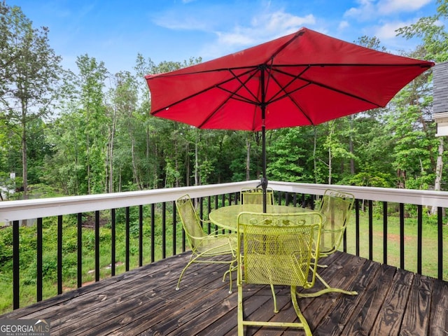 5293 Hopewell Ln, Gainesville, GA 30507 - wooden deck with outdoor dining space and a wooded view