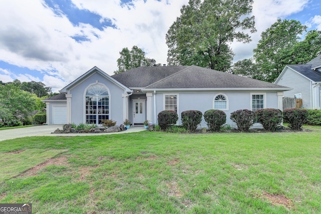 ranch-style home with stucco siding, an attached garage, and a front lawn