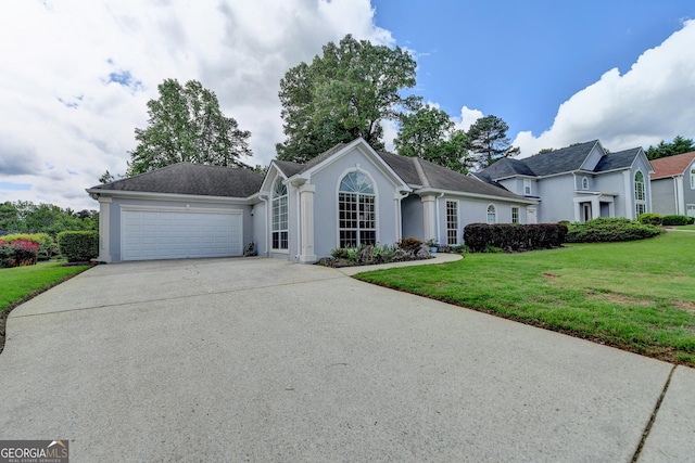 single story home with stucco siding, an attached garage, concrete driveway, and a front lawn