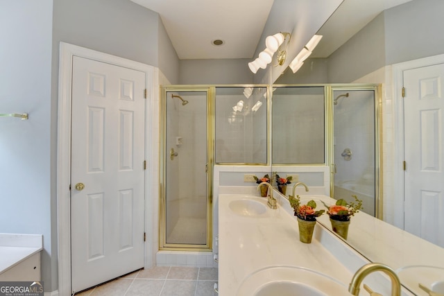 bathroom featuring tile patterned flooring, a stall shower, and double vanity