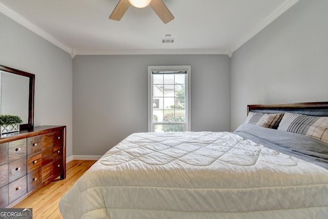 bedroom with crown molding, light wood finished floors, baseboards, and ceiling fan