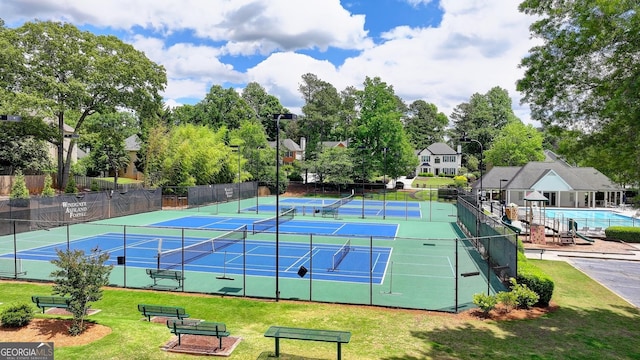 view of tennis court with view of scattered trees