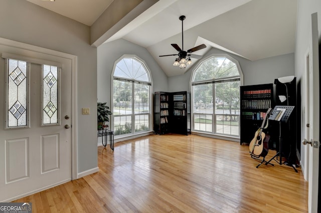 foyer entrance with light wood-style floors, ceiling fan, lofted ceiling, and baseboards
