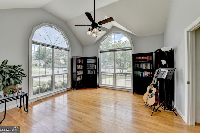 miscellaneous room with a ceiling fan, vaulted ceiling, and wood finished floors