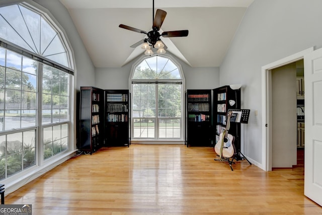 sitting room with wood finished floors, vaulted ceiling, ceiling fan, and baseboards