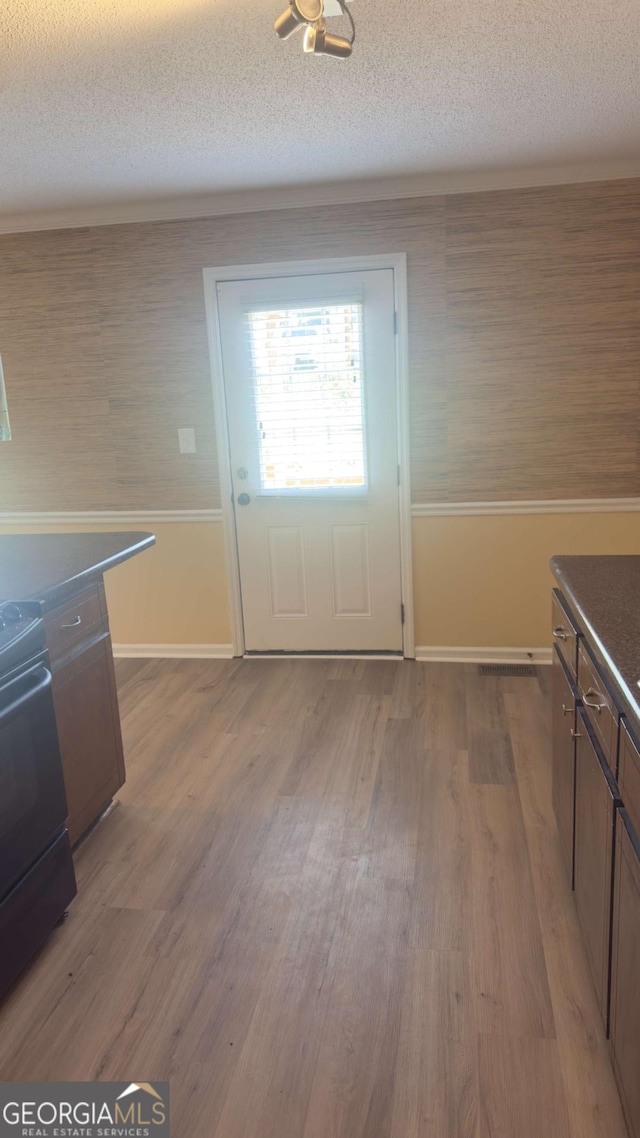 138 Tamara Ct, Athens, GA 30606 - kitchen with range, dark countertops, wood finished floors, a textured ceiling, and baseboards