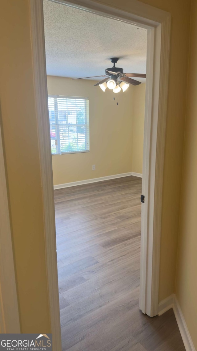 138 Tamara Ct, Athens, GA 30606 - empty room featuring dark wood finished floors, a ceiling fan, baseboards, and a textured ceiling