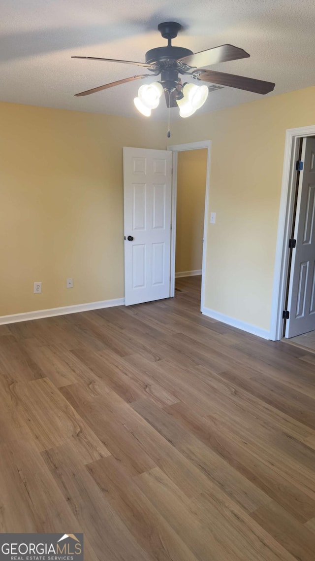 138 Tamara Ct, Athens, GA 30606 - unfurnished bedroom with baseboards, wood finished floors, and ceiling fan