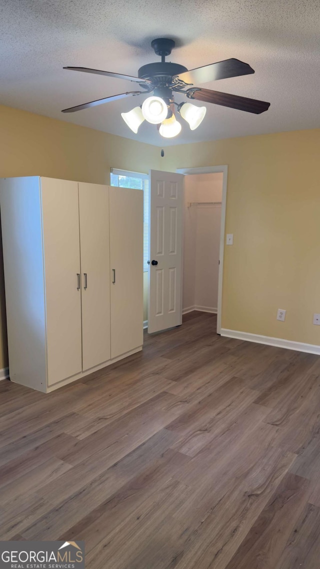 138 Tamara Ct, Athens, GA 30606 - unfurnished bedroom with wood finished floors, a textured ceiling, baseboards, and ceiling fan