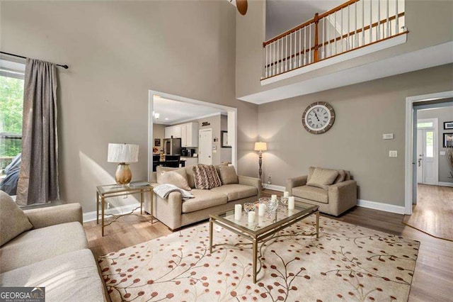 3705 Rolling Creek Dr, Buford, GA 30519 - living room featuring baseboards, wood finished floors, and a high ceiling