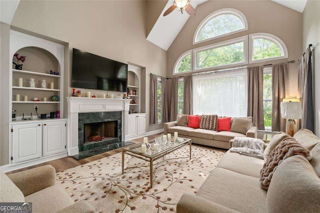 3705 Rolling Creek Dr, Buford, GA 30519 - living area with wood finished floors, high vaulted ceiling, a ceiling fan, a premium fireplace, and built in shelves