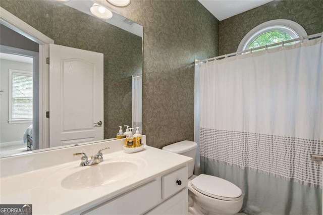 3705 Rolling Creek Dr, Buford, GA 30519 - bathroom featuring wallpapered walls, toilet, vanity, and curtained shower