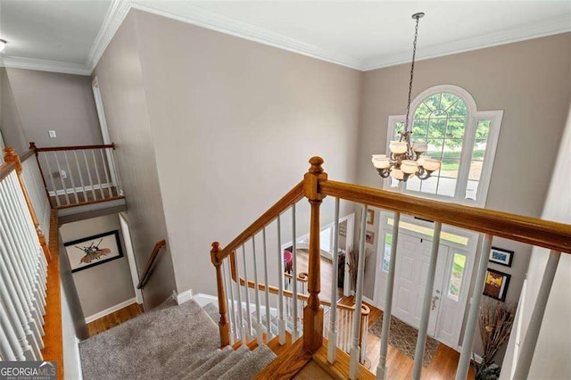 3705 Rolling Creek Dr, Buford, GA 30519 - stairs with a chandelier, wood finished floors, crown molding, and baseboards