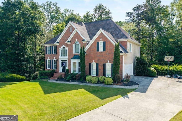 3705 Rolling Creek Dr, Buford, GA 30519 - colonial inspired home featuring driveway, an attached garage, brick siding, and a front yard