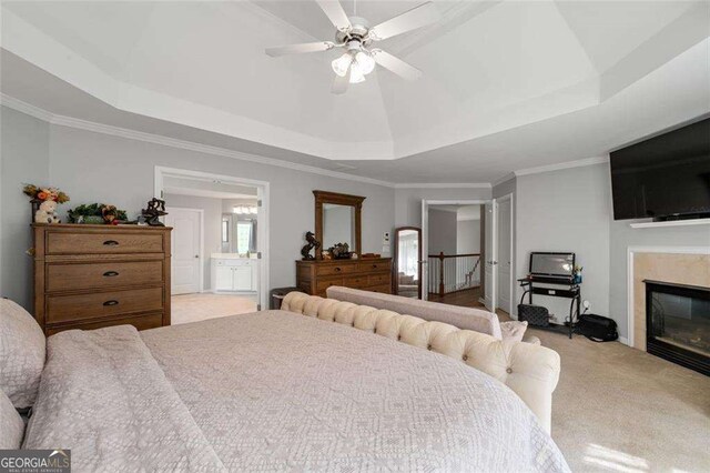 3705 Rolling Creek Dr, Buford, GA 30519 - bedroom with carpet flooring, a tray ceiling, a glass covered fireplace, crown molding, and connected bathroom