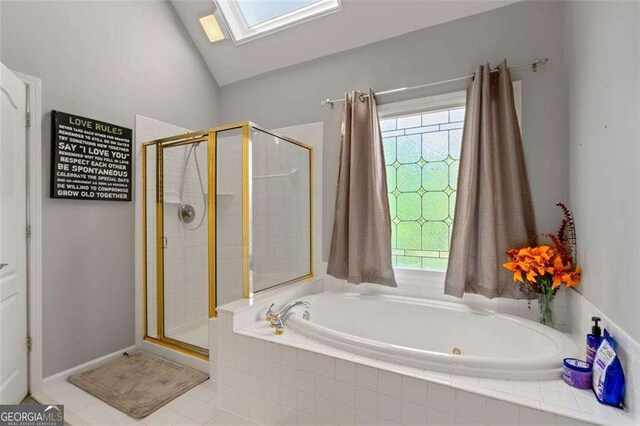3705 Rolling Creek Dr, Buford, GA 30519 - bathroom with a shower stall, a garden tub, a skylight, and vaulted ceiling