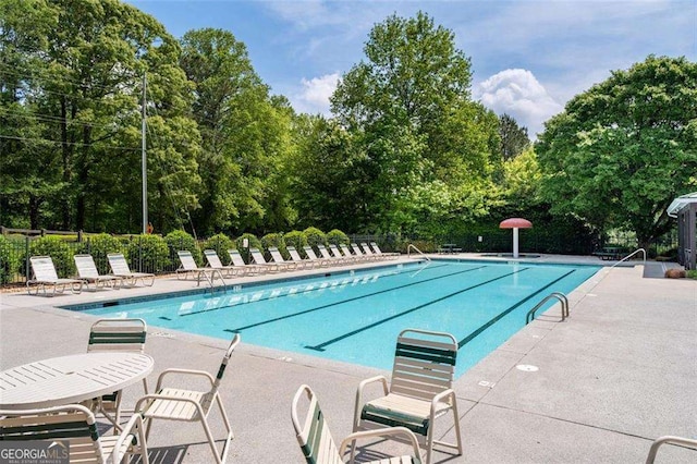 3705 Rolling Creek Dr, Buford, GA 30519 - community pool with fence, a patio, and view of scattered trees