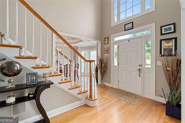 3705 Rolling Creek Dr, Buford, GA 30519 - entrance foyer with wood finished floors, baseboards, stairway, and a towering ceiling