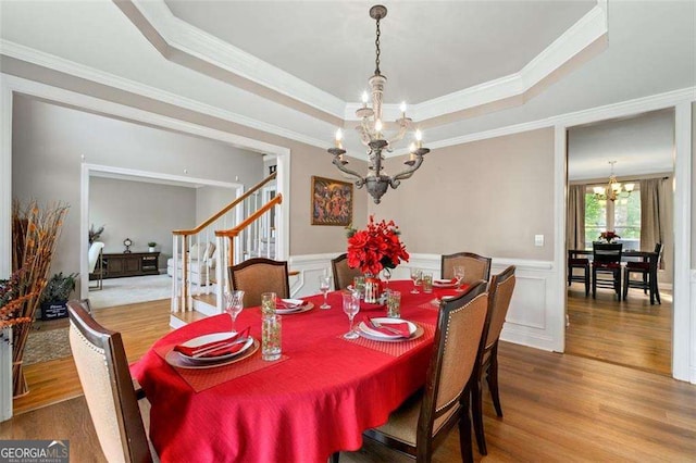 3705 Rolling Creek Dr, Buford, GA 30519 - dining space with a chandelier, wood finished floors, stairway, ornamental molding, and a tray ceiling