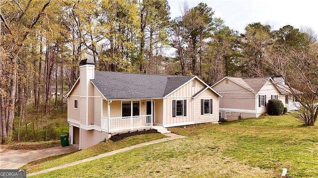 6092 Leverett Dr, Lithonia, GA 30038 - single story home with a porch, board and batten siding, a chimney, and a front yard