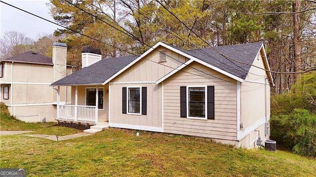 6092 Leverett Dr, Lithonia, GA 30038 - back of house featuring a porch, a shingled roof, a yard, and a chimney
