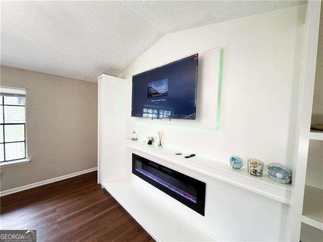 6092 Leverett Dr, Lithonia, GA 30038 - unfurnished living room with a textured ceiling, dark wood-style floors, lofted ceiling, and baseboards