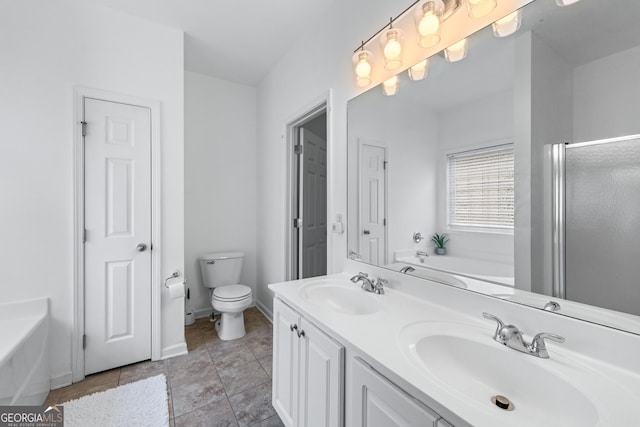 6045 Park Close, Fairburn, GA 30213 - full bathroom featuring a bath, toilet, baseboards, and double vanity