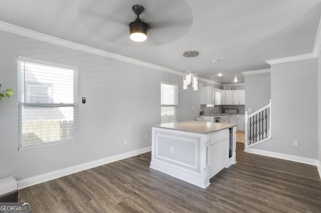 1560 Sarah M Harden Dr, Atlanta, GA 30311 - kitchen with ornamental molding, white cabinetry, baseboards, a ceiling fan, and a sink