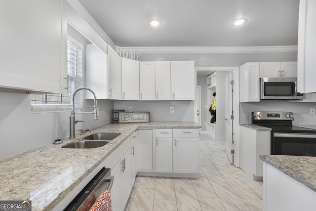 1560 Sarah M Harden Dr, Atlanta, GA 30311 - kitchen with stainless steel appliances, a sink, white cabinetry, crown molding, and light marble finish floors