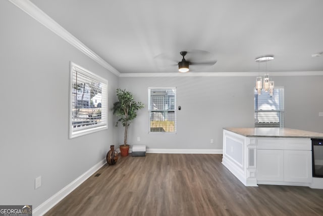 1560 Sarah M Harden Dr, Atlanta, GA 30311 - unfurnished dining area featuring dark wood-style flooring, a ceiling fan, crown molding, baseboards, and a chandelier