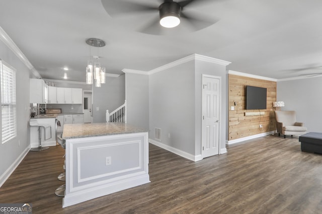 1560 Sarah M Harden Dr, Atlanta, GA 30311 - kitchen featuring ceiling fan, white cabinetry, baseboards, ornamental molding, and light stone countertops