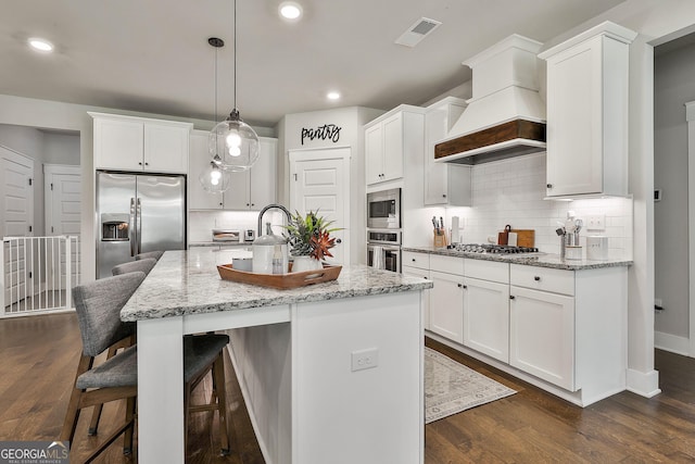 kitchen with appliances with stainless steel finishes, decorative backsplash, white cabinets, and recessed lighting