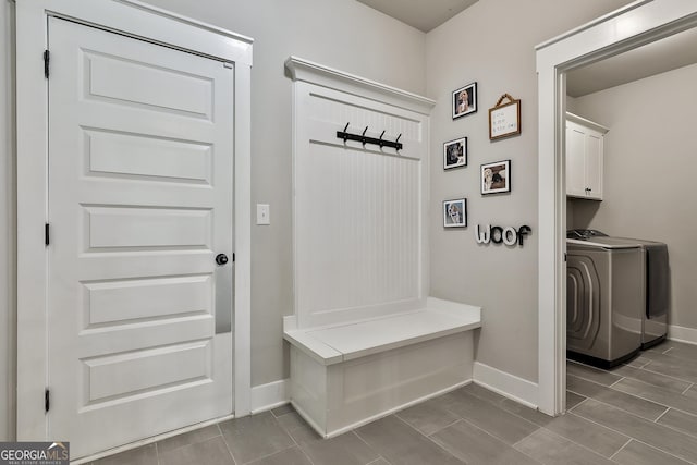 mudroom with washing machine and dryer and baseboards