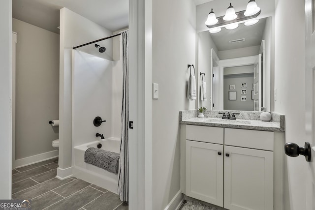 full bathroom featuring baseboards, toilet, shower / tub combination, and vanity
