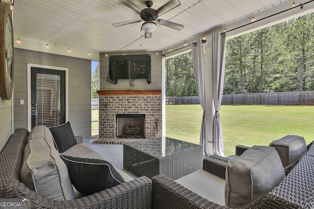 view of patio / terrace featuring an outdoor living space with a fireplace and a ceiling fan
