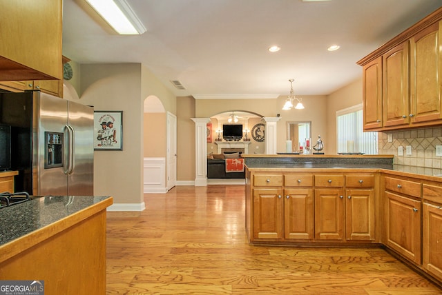 4765 Smokestone Dr, Douglasville, GA 30135 - kitchen with stainless steel refrigerator with ice dispenser, ornate columns, arched walkways, decorative backsplash, and light wood finished floors