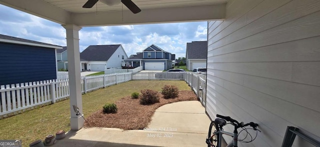 view of yard with ceiling fan and a residential view