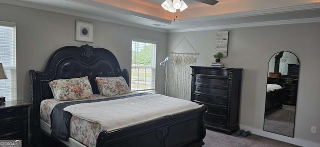 bedroom with carpet flooring, a raised ceiling, ornamental molding, ceiling fan, and baseboards